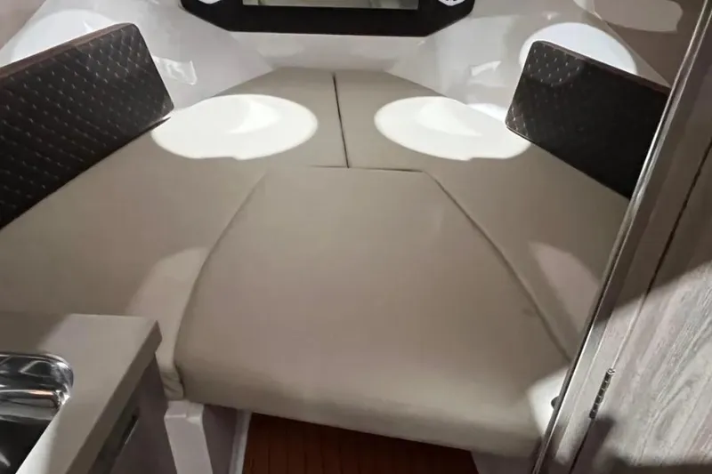 Slide: The Image of 2025 Ventura Daycruiser interior cabin with cushioned seating and modern design. - 6