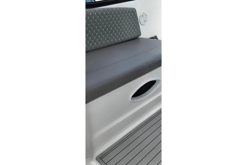 Slide: The Image of Ventura Daycruicer 2025 boat interior with cushioned seating and sleek design. - 7