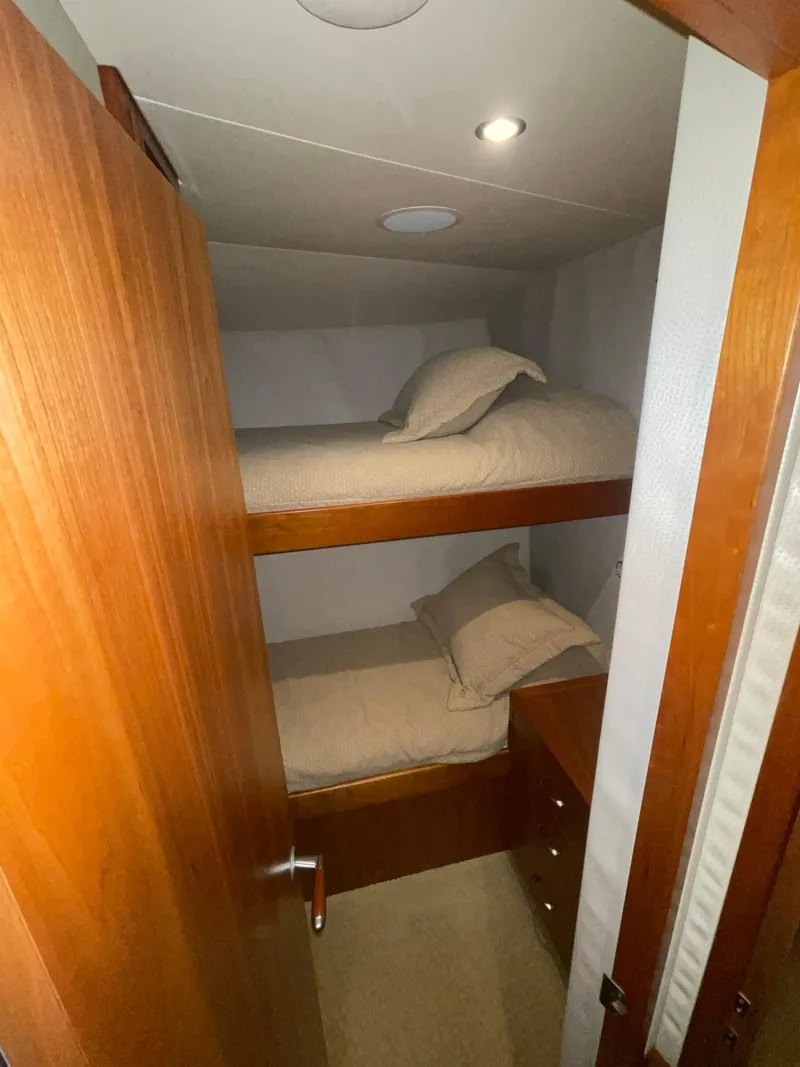 Slide: The Image of Bunk beds in 2013 Hatteras GT63 yacht cabin with wooden interior. - 13