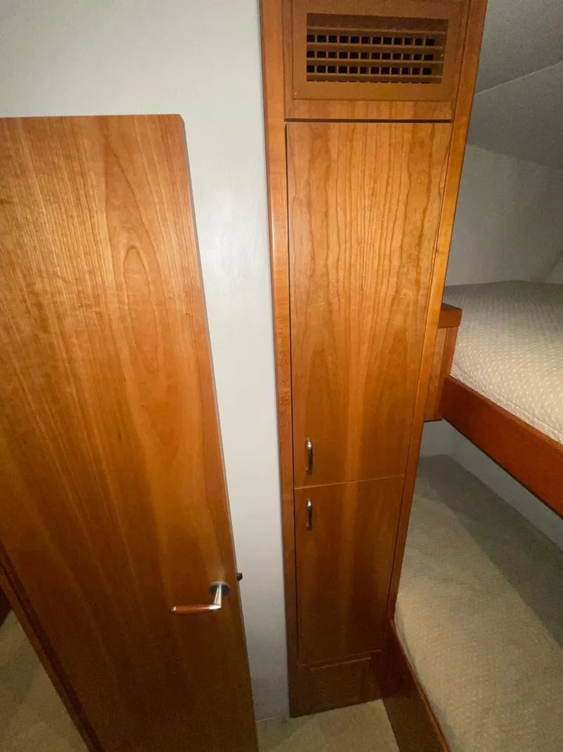 Slide: The Image of Interior of 2013 Hatteras GT63 yacht with wooden cabinetry and bunk bed. - 15