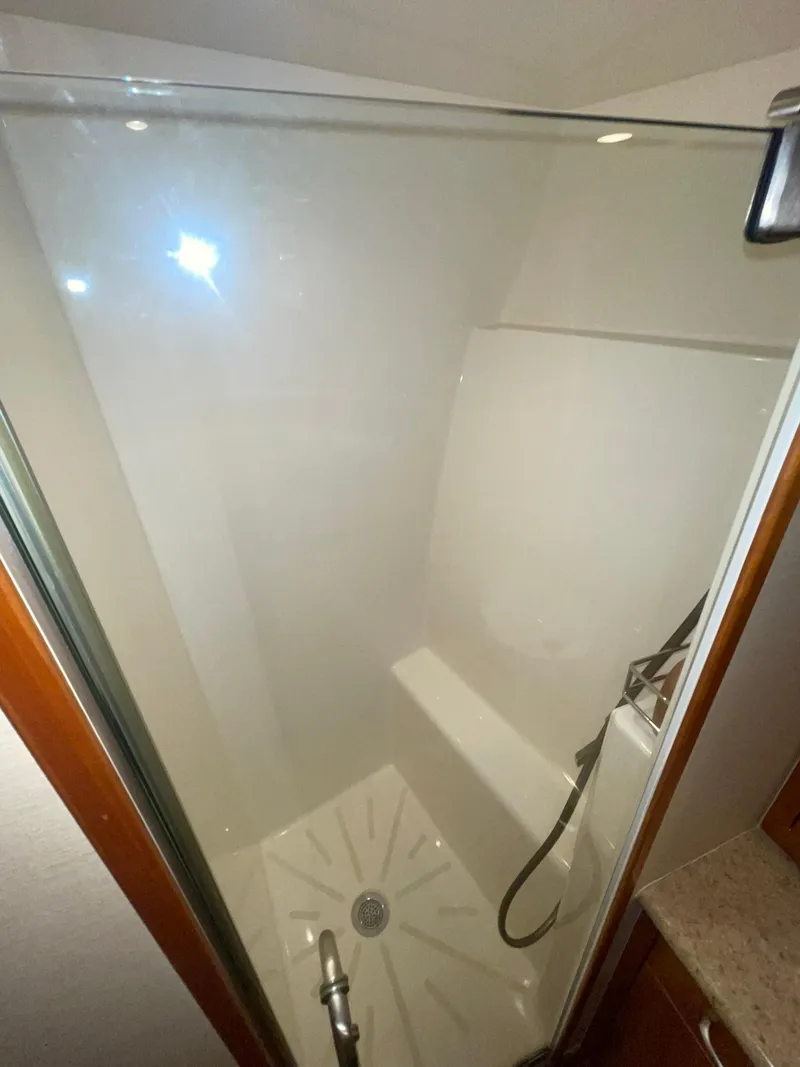 Slide: The Image of Shower area in 2013 Hatteras GT63 yacht with glass door and modern fixtures. - 22