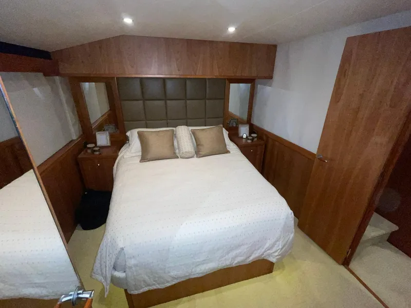 Slide: The Image of Luxurious bedroom interior of 2013 Hatteras GT63 yacht with elegant wood finishes. - 23
