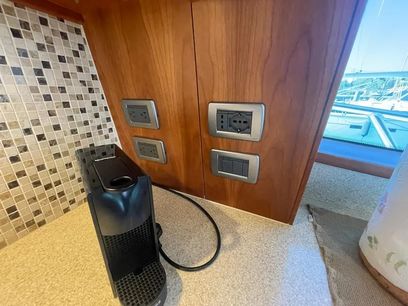 Slide: The Image of Power outlets and coffee machine on Hatteras GT63 yacht, 2013 model, with tiled backsplash. - 32