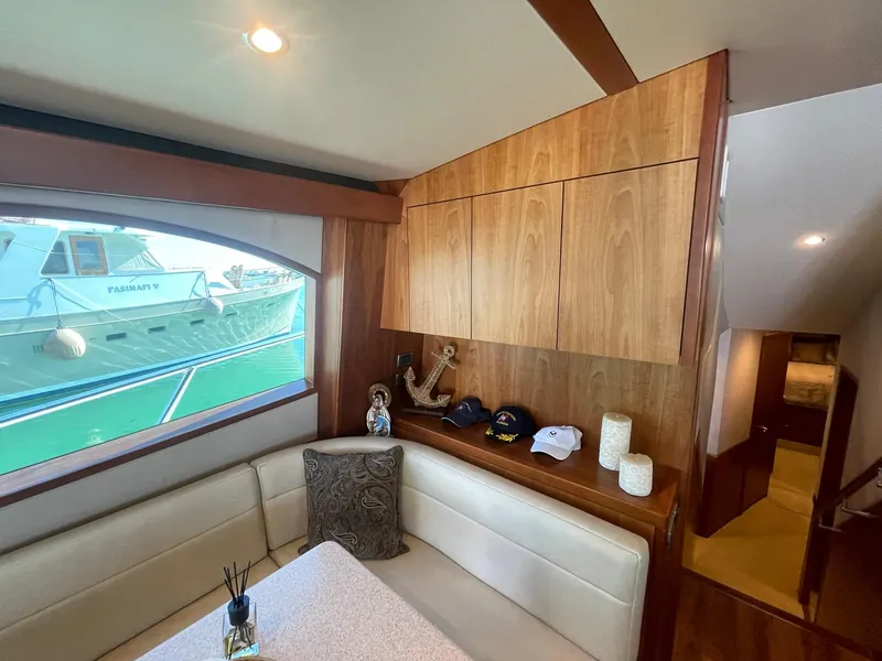Slide: The Image of Interior of 2013 Hatteras GT63 yacht with dining area and window view. - 34