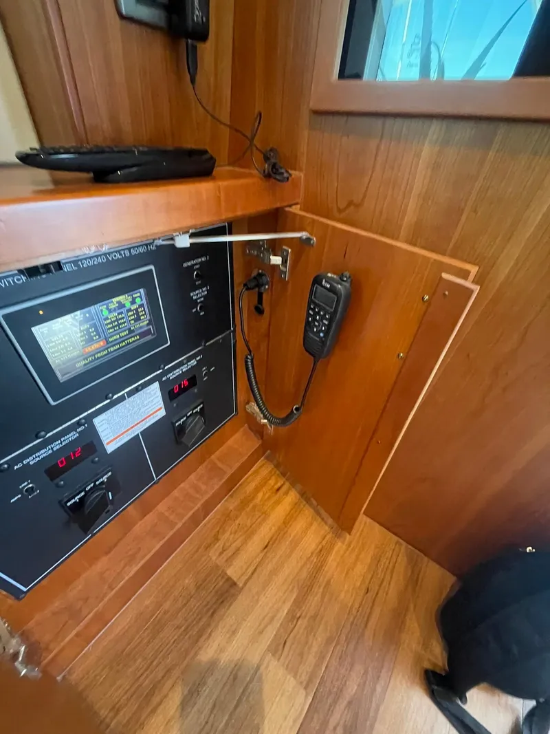 Slide: The Image of 2013 Hatteras GT63 yacht interior with control panel and communication device. - 46