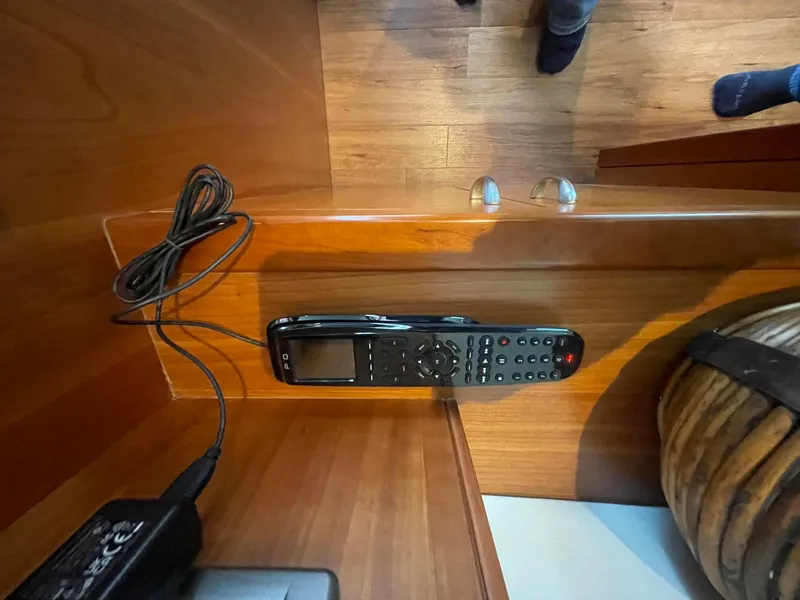 Slide: The Image of Remote control on wooden surface inside 2013 Hatteras GT63 yacht interior. - 47