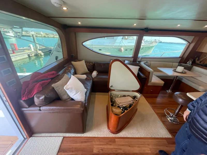 Slide: The Image of Luxurious interior of 2013 Hatteras GT63 yacht with leather seating and marina view. - 48