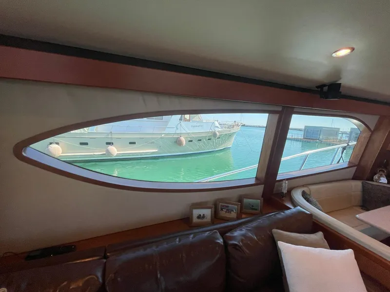 Slide: The Image of Interior view of 2013 Hatteras GT63 yacht, showcasing window with ocean view. - 50