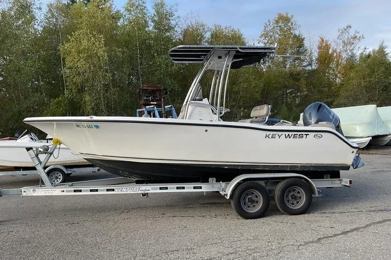 Slide: The Image of 2023 Key West 203 FS boat on trailer, parked outdoors. - 10