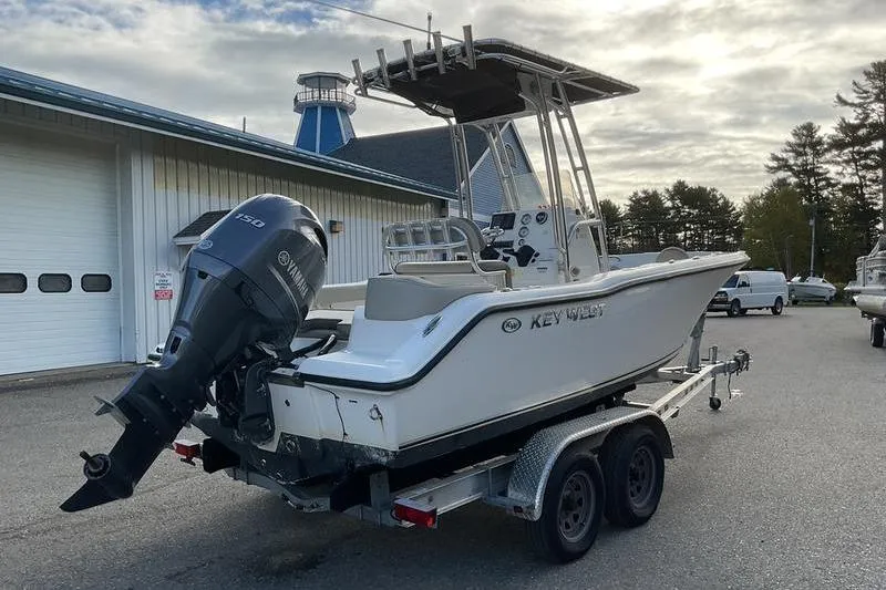 Slide: The Image of 2023 Key West 203 FS boat on trailer with Yamaha outboard motor, parked outdoors. - 8