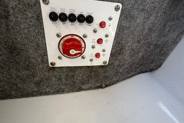 Slide: The Image of Control panel of a 2020 Scarab 195 ID boat with switches and red dial. - 14