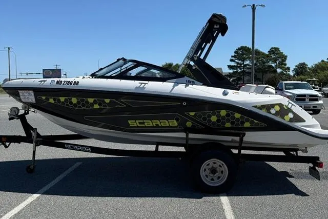 Slide: The Image of 2020 Scarab 195 ID boat on trailer in parking lot, side view. - 5