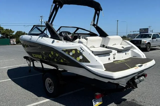 Slide: The Image of 2020 Scarab 195 ID boat in parking lot, featuring sleek design and modern graphics. - 6