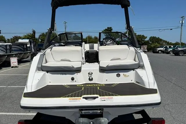 Slide: The Image of 2020 Scarab 195 ID boat, rear view, parked in a lot under clear blue sky. - 7