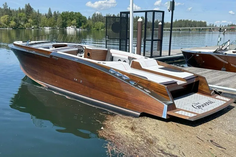 The Image of 2020 StanCraft 290 Rivelle luxury wooden boat docked on a serene lake. - 1
