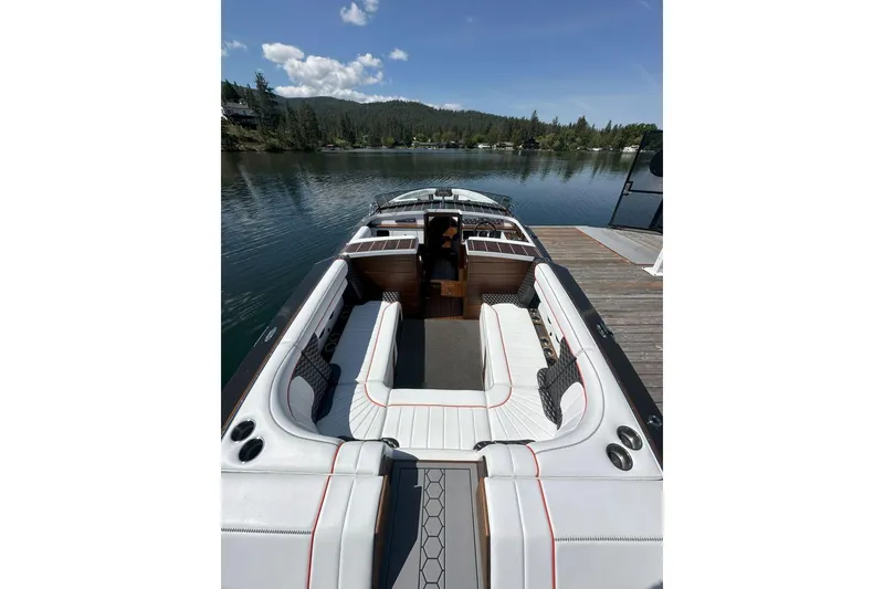 Slide: The Image of 2020 StanCraft 290 Rivelle boat interior with luxurious seating on a serene lake. - 3