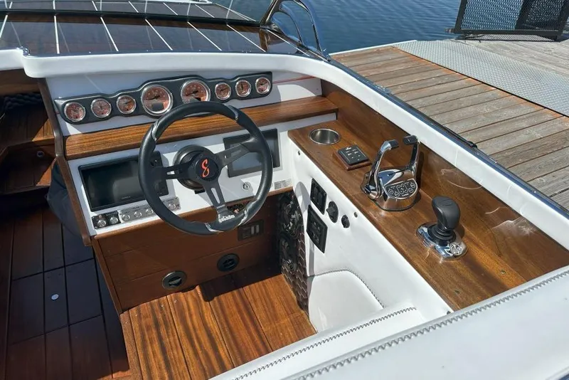 Slide: The Image of 2020 StanCraft 290 Rivelle boat dashboard with wooden accents and modern controls. - 5