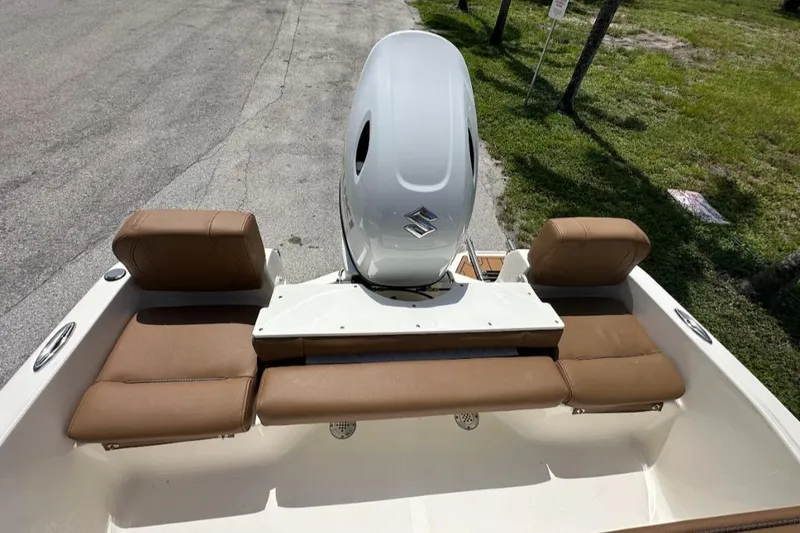 Slide: The Image of 2025 Pioneer 180 Islander boat with brown seating and Suzuki outboard motor. - 3