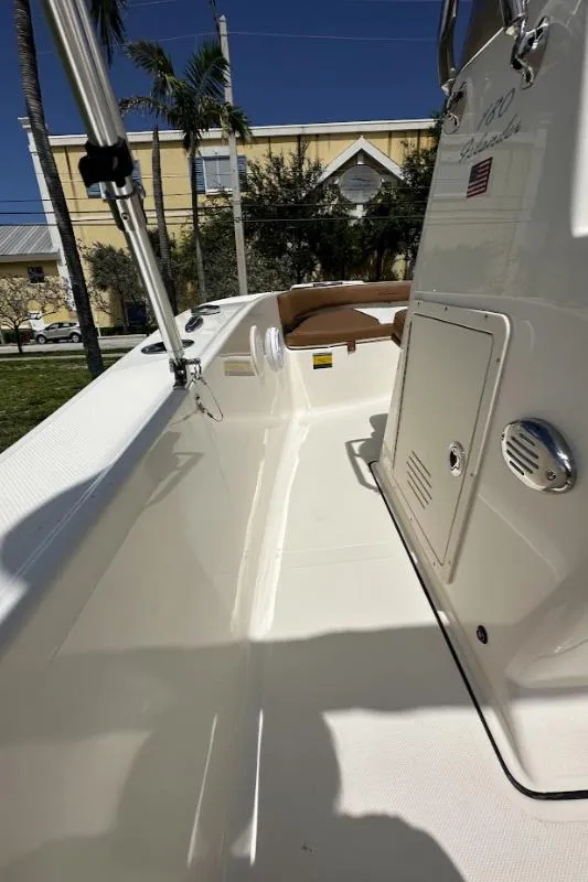 Slide: The Image of 2025 Pioneer 180 Islander boat interior with sleek white design and modern features. - 8