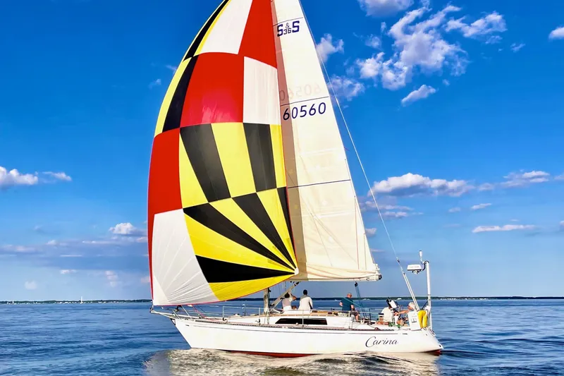 The Image of Sailing yacht Sparkman & Stephens 36, 1988 model, with colorful spinnaker on open water. - 0