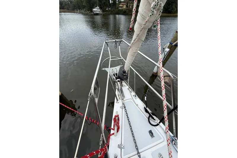 Slide: The Image of Bow view of 1988 Sparkman & Stephens 36 sailboat docked on calm water. - 13