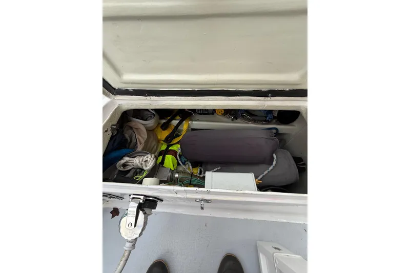 Slide: The Image of Storage compartment of a 1988 Sparkman & Stephens 36 sailboat, containing various boating equipment. - 22