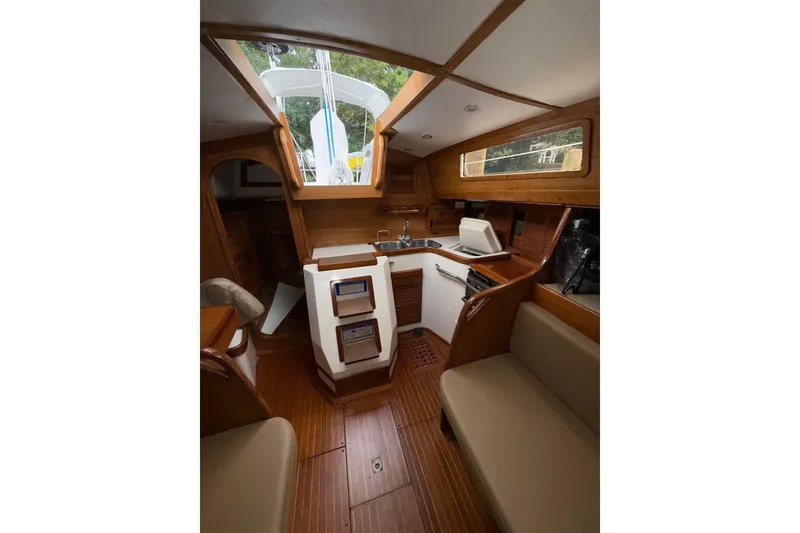 Slide: The Image of Interior of 1988 Sparkman & Stephens 36 sailboat with wooden finishes and compact kitchen area. - 26