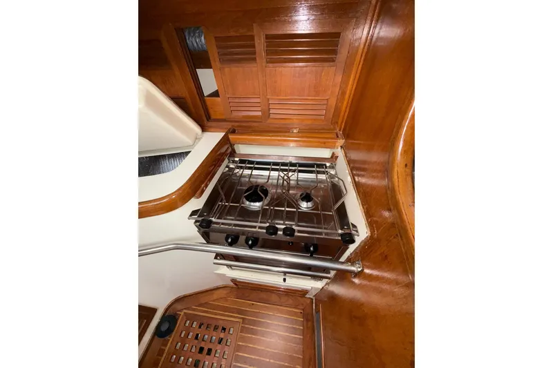 Slide: The Image of 1988 Sparkman & Stephens 36 yacht interior with wooden cabinetry and compact stove. - 27