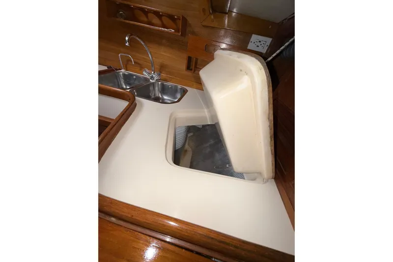 Slide: The Image of Interior of 1988 Sparkman & Stephens 36 yacht showing kitchen sink and storage area. - 28