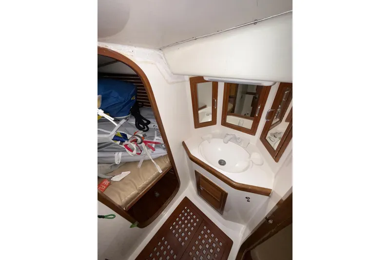 Slide: The Image of Interior of 1988 Sparkman & Stephens 36 sailboat, featuring a compact bathroom with sink and mirrors. - 33