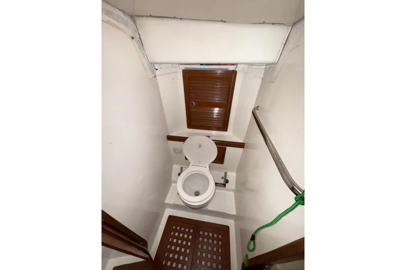 Slide: The Image of Toilet area in 1988 Sparkman & Stephens 36 yacht, featuring wooden accents and compact design. - 35