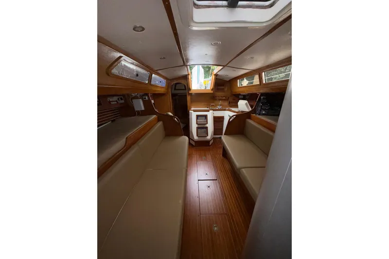Slide: The Image of Interior of 1988 Sparkman & Stephens 36 sailboat with wooden finish and seating area. - 36