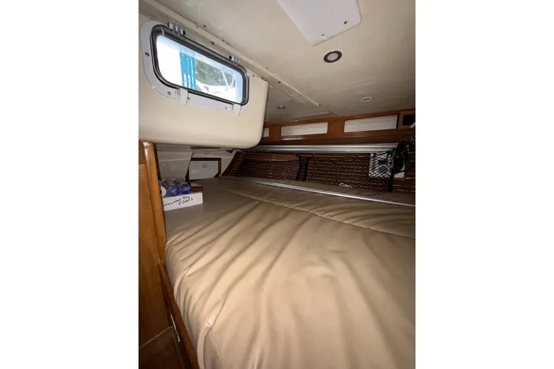Slide: The Image of Interior cabin of 1988 Sparkman & Stephens 36 sailboat with beige bedding. - 42
