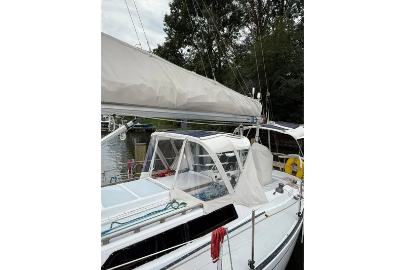 Slide: The Image of 1988 Sparkman & Stephens 36 sailboat docked, featuring a covered cockpit and rigging. - 5