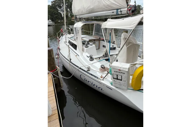 Slide: The Image of 1988 Sparkman & Stephens 36 sailboat docked, featuring white hull and lifebuoy. - 7