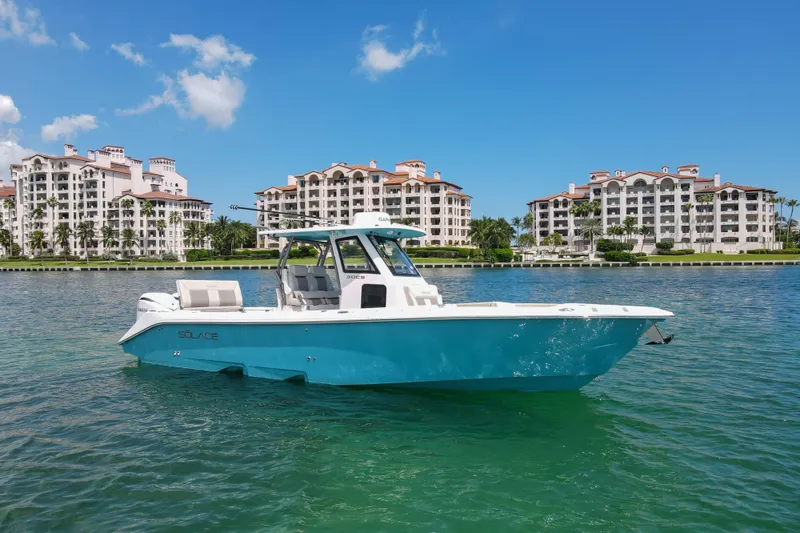 The Image of 2026 Solace 30 CS boat on water, with luxury waterfront buildings in the background. - 0