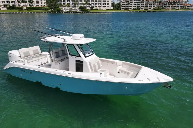 Slide: The Image of 2026 Solace 30 CS boat on clear blue water, showcasing sleek design and modern features. - 3