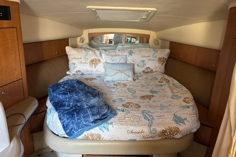 Slide: The Image of Cozy cabin interior of 2006 Sea Ray Sundancer 320 with nautical-themed bedding. - 17