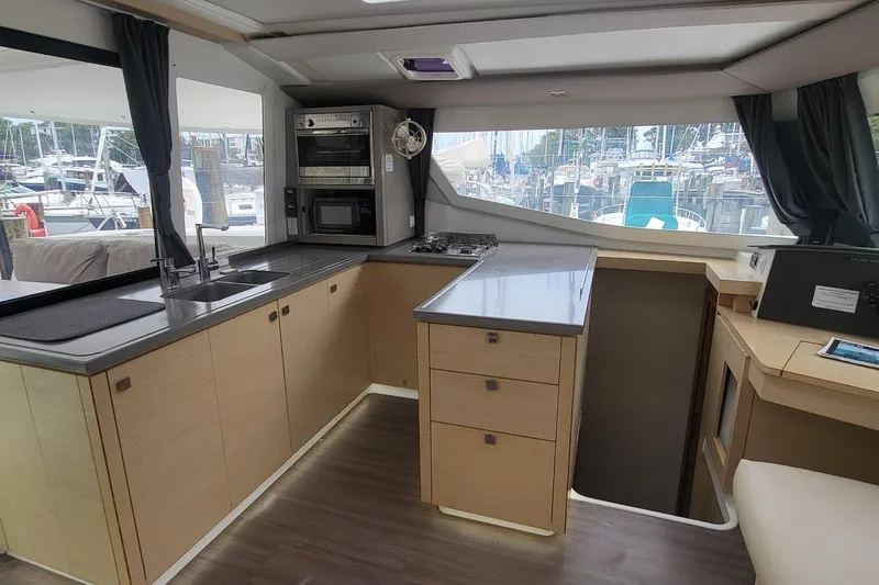 Slide: The Image of Modern kitchen interior of 2018 Fountaine Pajot Helia 44 catamaran, featuring sleek cabinetry and appliances. - 13