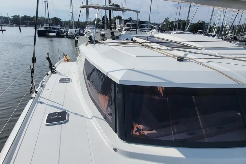 Slide: The Image of 2018 Fountaine Pajot Helia 44 catamaran docked at marina, showcasing sleek design and spacious deck. - 30