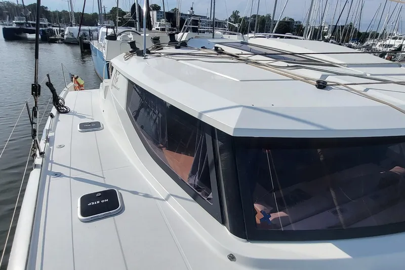 Slide: The Image of 2018 Fountaine Pajot Helia 44 catamaran docked at marina, showcasing sleek design and spacious deck. - 31