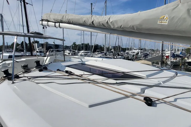 Slide: The Image of 2018 Fountaine Pajot Helia 44 catamaran docked at a marina, showcasing deck and rigging. - 32