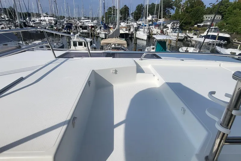 Slide: The Image of Fountaine Pajot Helia 44 catamaran deck, 2018 model, docked at a marina with multiple boats. - 38