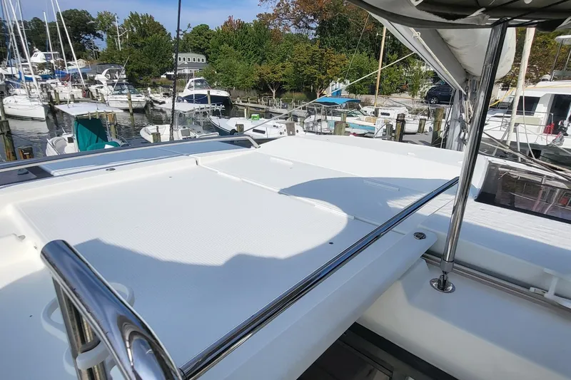 Slide: The Image of 2018 Fountaine Pajot Helia 44 catamaran docked at a marina, showcasing spacious deck. - 39