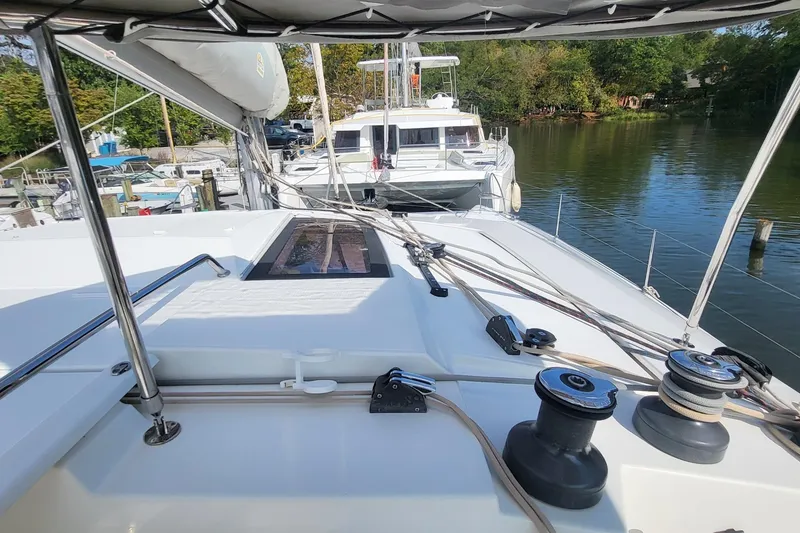 Slide: The Image of 2018 Fountaine Pajot Helia 44 catamaran docked in a serene marina setting. - 40