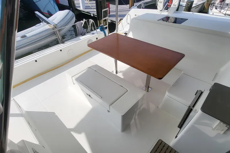 Slide: The Image of 2018 Fountaine Pajot Helia 44 yacht cockpit with wooden table and seating. - 42