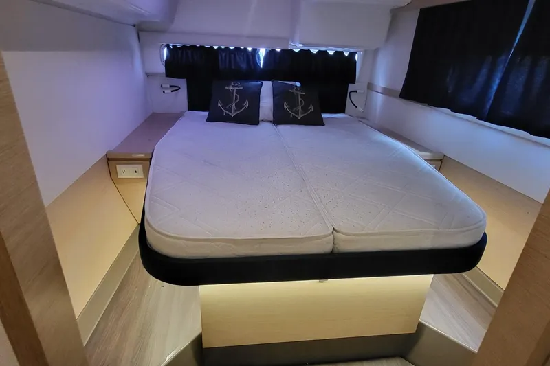 Slide: The Image of 2018 Fountaine Pajot Helia 44 cabin interior with bed and anchor-themed pillows. - 45
