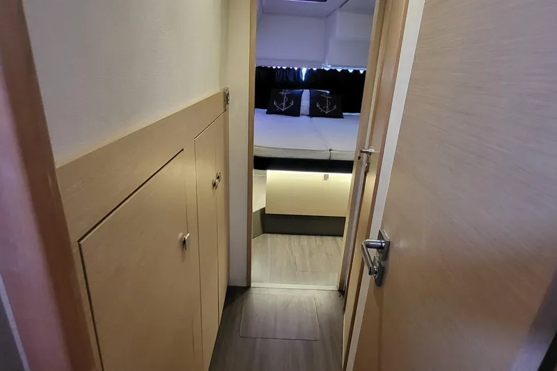 Slide: The Image of 2018 Fountaine Pajot Helia 44 cabin interior with modern wood finish and cozy bedding. - 46