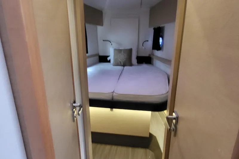 Slide: The Image of Cabin interior of 2018 Fountaine Pajot Helia 44 catamaran with cozy bed and ambient lighting. - 49