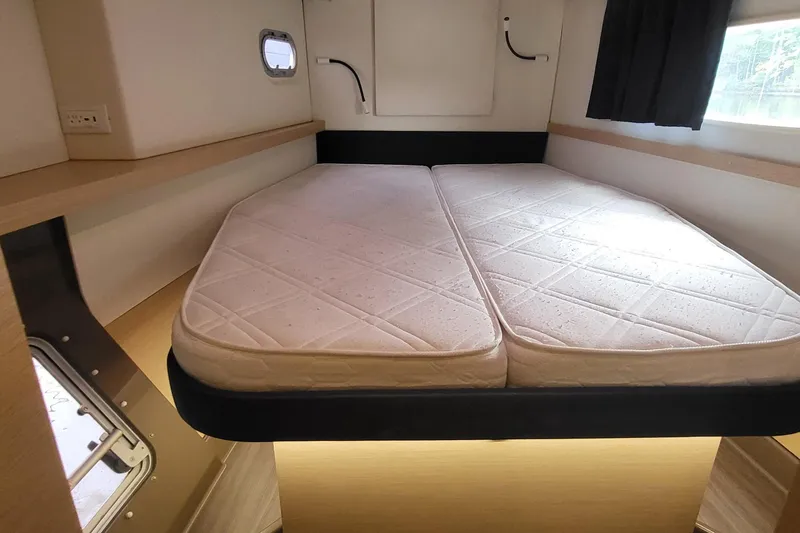 Slide: The Image of Interior cabin of 2018 Fountaine Pajot Helia 44 with double bed and porthole windows. - 7